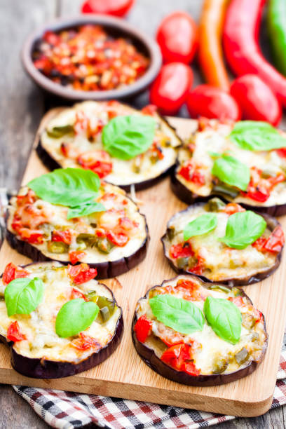 istock Baked  eggplant with cheese and tomatoes on cutting board 848654540