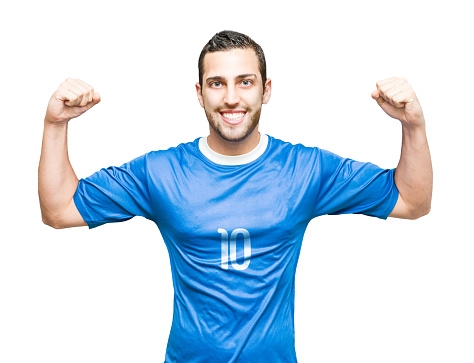 Football player man in a blue jersey with the pose of tackling the ball isolated over white background