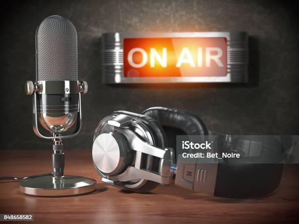 Vintage Microphone And Headphones With Signboard On Air Broadcasting Radio Station Concept Stock Photo - Download Image Now