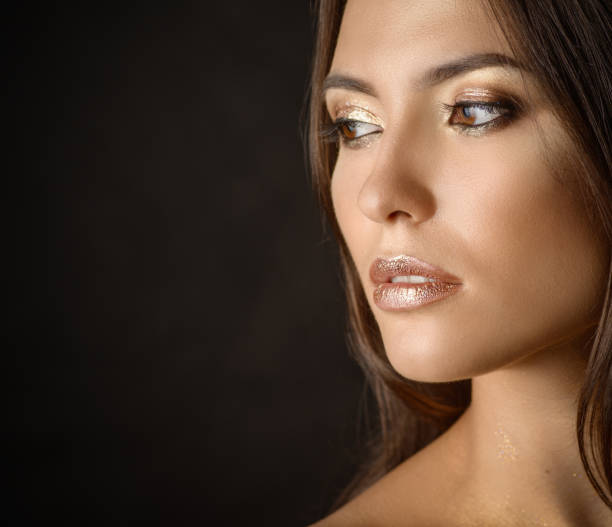 istock Woman with golden makeup. 848661456