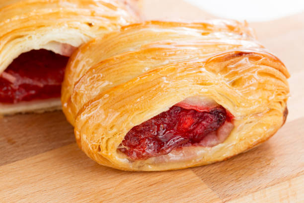 Puff pastry pies with cherry and honey. Puff pastry pies with cherry and honey.. on white background. on wooden plate mark goodson screening room stock pictures, royalty-free photos & images