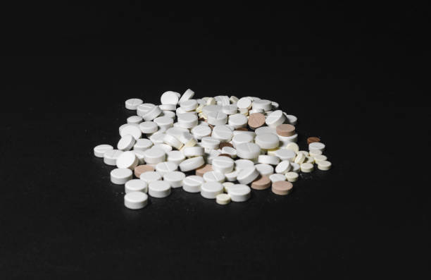 istock Handful of pills on a black background closeup 848679376
