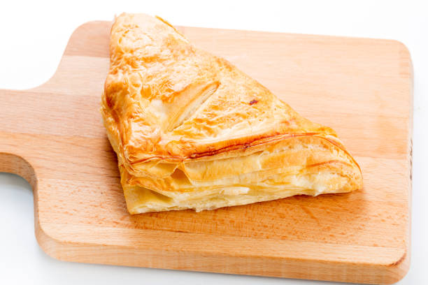 Puff pastry pies with cranberries, apples and honey. Puff pastry pies with plums, apples, mint and honey. on white background. on wooden plate mark goodson screening room stock pictures, royalty-free photos & images