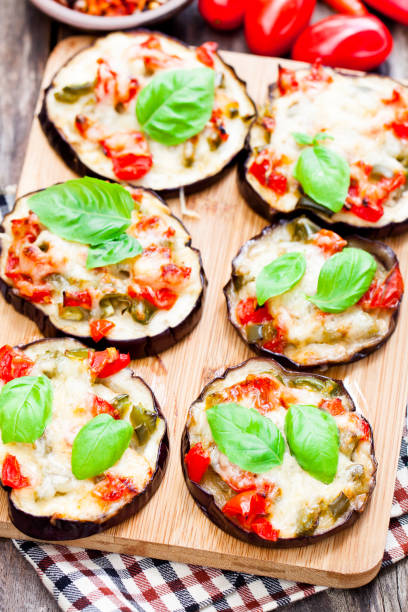 istock Baked  eggplant with cheese and tomatoes on cutting board 848682730