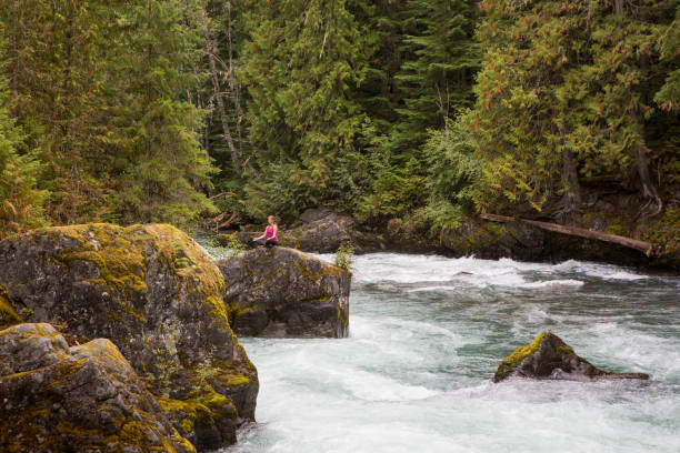 istock Fit woman doing yoga next to the river 848683584