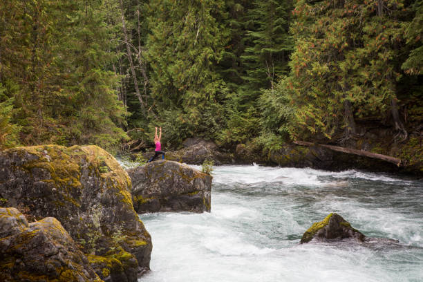 istock Female standing on a rock doing some yoga 848684628
