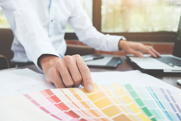 istock Graphic design and color swatches and pens on a desk. Architectural drawing with work tools and accessories. 848690868