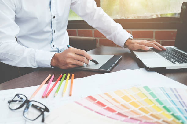 istock Graphic design and color swatches and pens on a desk. Architectural drawing with work tools and accessories. 848690876