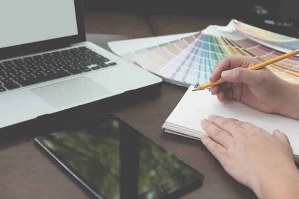istock Graphic design and color swatches and pens on a desk. Architectural drawing with work tools and accessories. 848690890