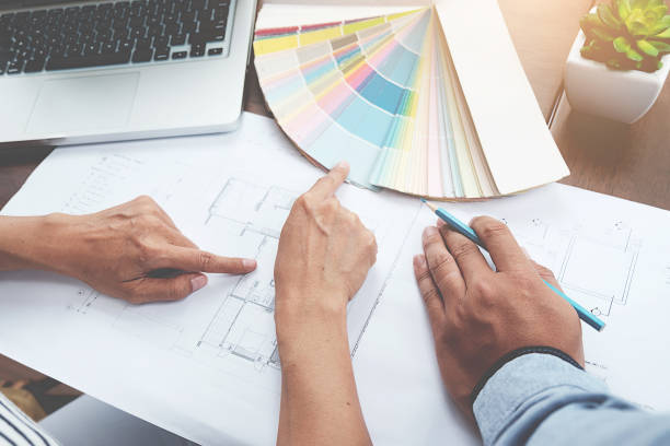 istock Graphic design and color swatches and pens on a desk. Architectural drawing with work tools and accessories. 848690900