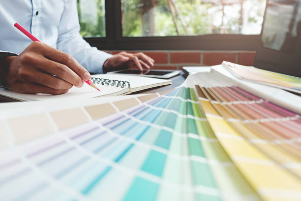 istock Graphic design and color swatches and pens on a desk. Architectural drawing with work tools and accessories. 848690904