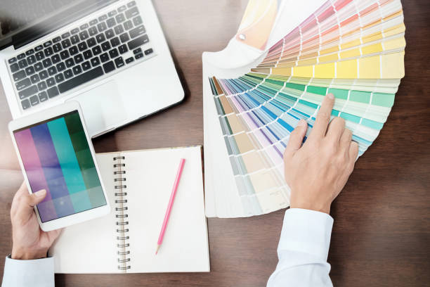istock Graphic design and color swatches and pens on a desk. Architectural drawing with work tools and accessories. 848690948
