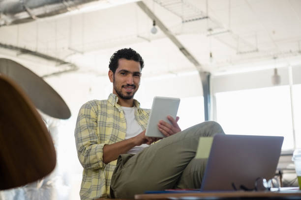 istock Portrait of young man using tablet in office 848695202