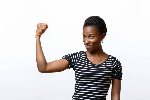 istock Cute young African woman flexing her muscles 848695660