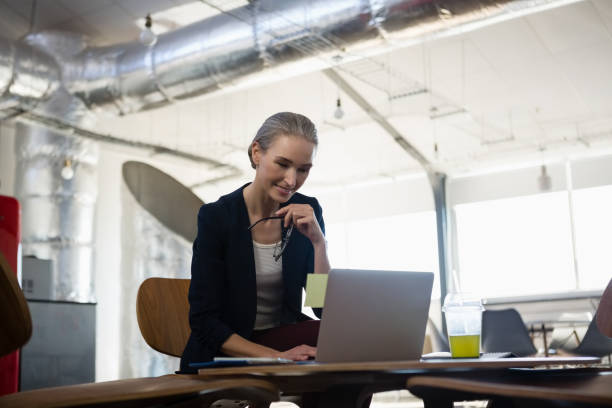 istock Young businesswoman using laptop in office 848695686