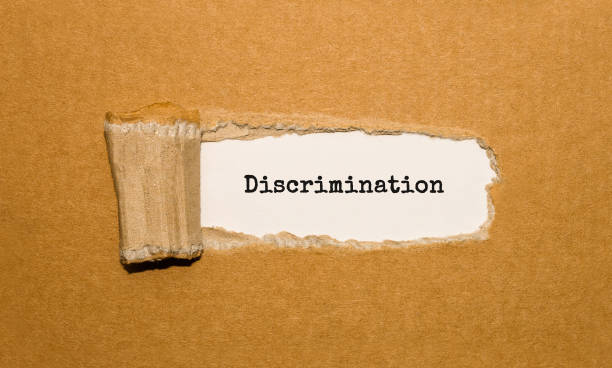 istock The text Discrimination appearing behind torn brown paper 848700916