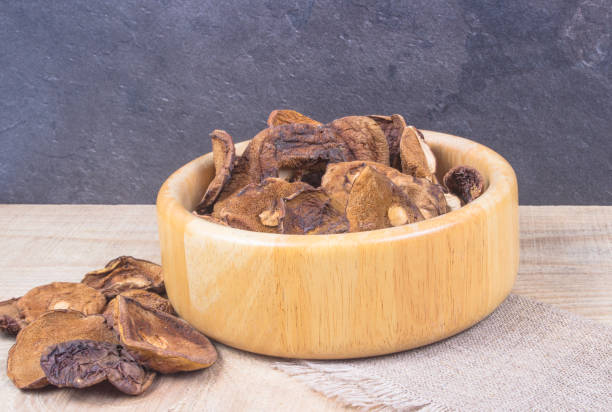 istock Dried forest mushrooms on a wooden table. 848701370