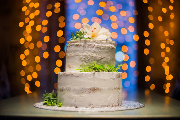 istock Split-level wedding cake with natural flowers on bokeh background 848702352