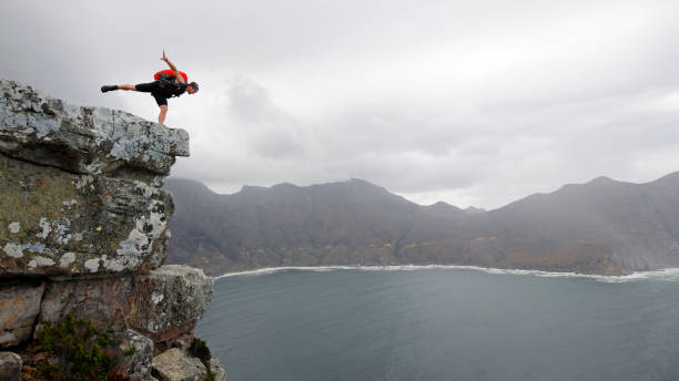 People extreme sport base-jumping squirrel-suite rock-climbing parachute ocean mountains red bull stock photo