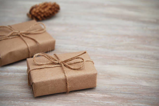 istock Small Gift box wraped in recycled paper with ribbon bow, isolated 848708338