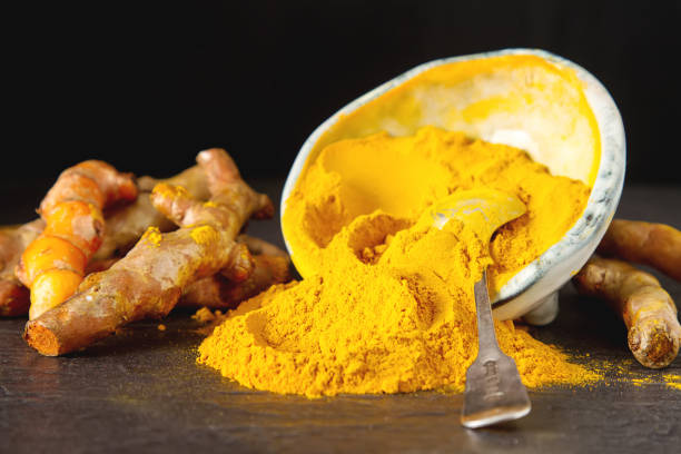 istock Turmeric powder and fresh turmeric. Dark background. Space for text. 848708562