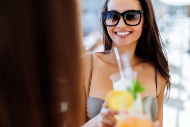 istock Beautiful women on beach enjoying cocktails 848709062