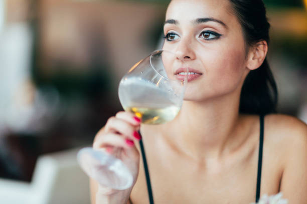 istock Attractive woman tasting white wine 848709308