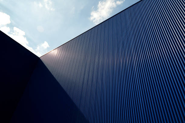 corrugated metal sheet blue color Metal sheet wall panels and roofs against clear blue sky corrugated iron stock pictures, royalty-free photos & images