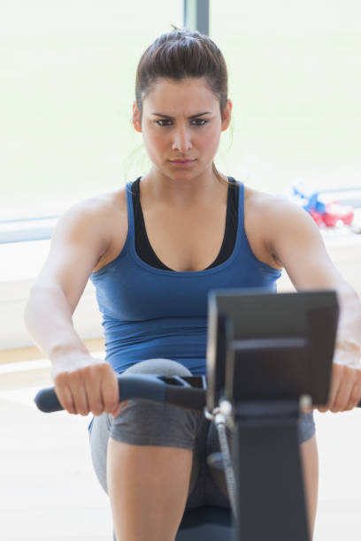 istock Focused woman at the rowing machine 848720726