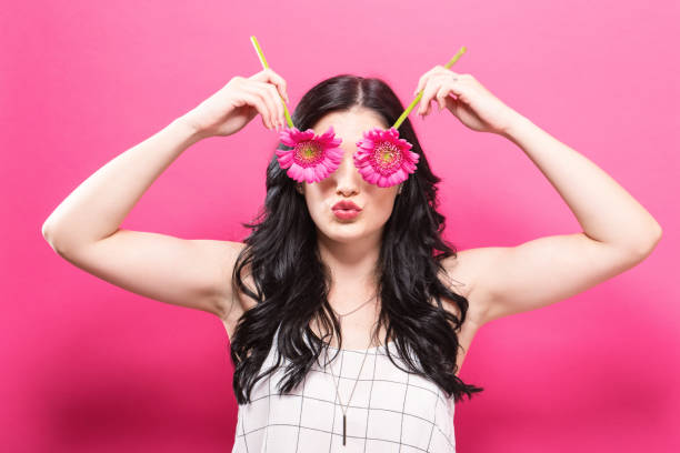 istock Young woman with flowers 848721066