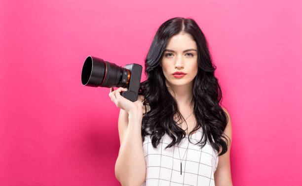 istock Young woman holding a camera 848721072