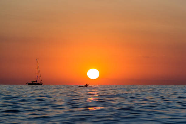 istock Sunrise with boat and kayak 848734486