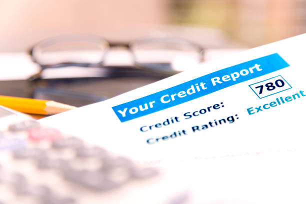 istock Credit report, score, loan documents, digital tablet, eyeglasses, and calculator on desk. 848741478