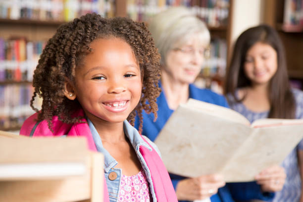 istock African descent little girl in school library. 848744862