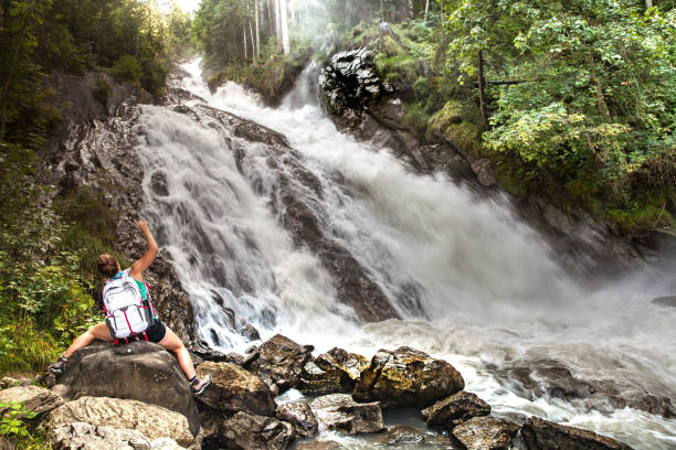 istock Young Woman waiving at Water Fall 848745780