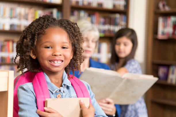 istock African descent little girl in school library. 848745794
