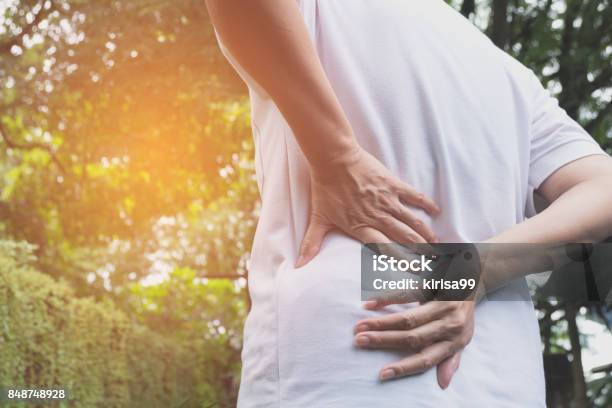 A Man Suffering From Backache Spinal Injury And Muscle Issue Problem At Outdoor Stock Photo - Download Image Now