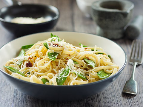 Home made freshness linguine with mangetout  and chopped hazelnut and parmesan cheese