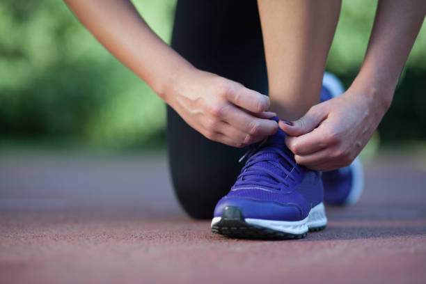 istock Pretty fitness instructor tying shoes 848749192