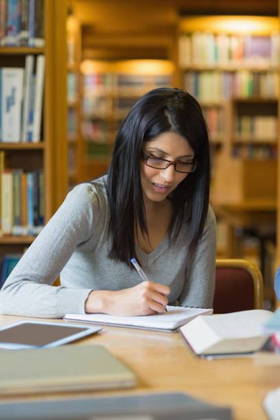 istock Woman doing some research in the library 848756410