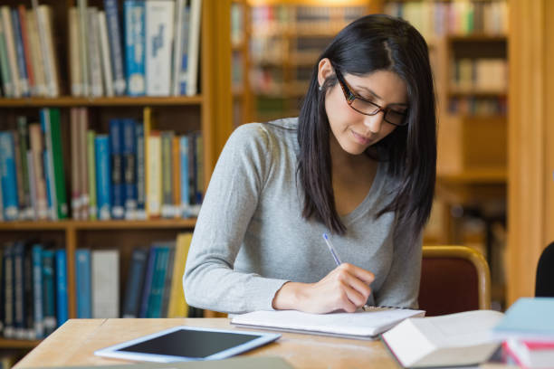 istock Woman studying in the library 848758500