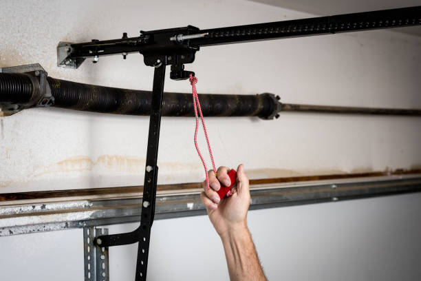 Man pulls red quick release for a garage door opener Red handle that release a garage door from opener door panel stock pictures, royalty-free photos & images