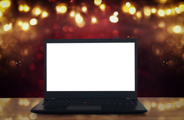 istock open laptop with white screen on wooden table in front of abstract glitter background 848758978