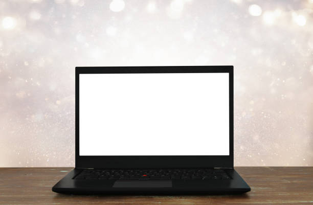 istock open laptop with white screen on wooden table in front of abstract glitter background 848759026