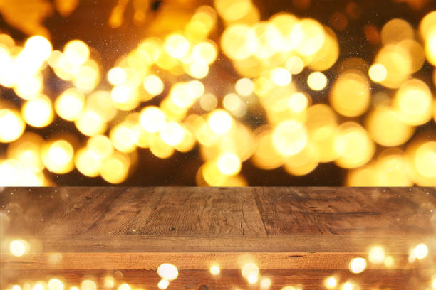 istock Empty table in front of black and gold glitter lights background 848759072
