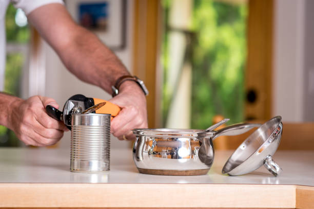 istock Opening a can of chili with a can opener 848759452
