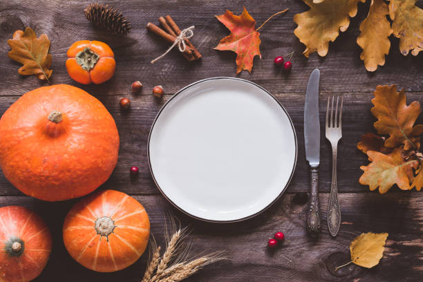 istock Autumn thanksgiving table setting with empty plate, cutlery and pumpkins 848762422