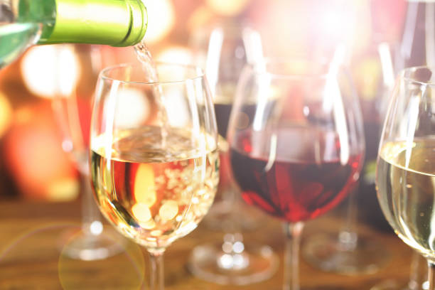 navidad, vinos de fiesta de año nuevo con luces. - wine pouring wineglass white wine fotografías e imágenes de stock