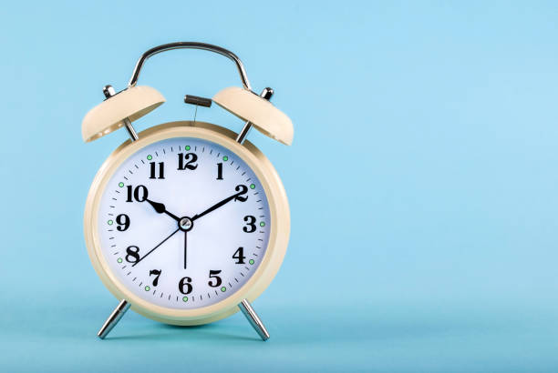 istock Old alarm clock isolated on a blue background with space for text 848765720