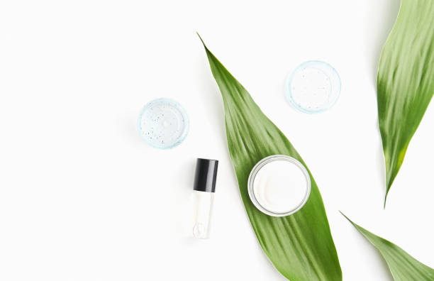 istock White cream bottle placed, Blank label package for mock up on a green foliage background and flowers. The concept of natural beauty products. 848768264